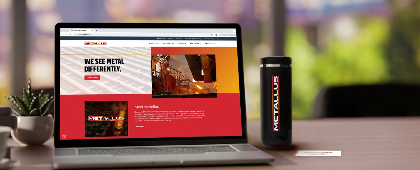 Photo of laptop with Metallus' new website and a Metallus coffee cup